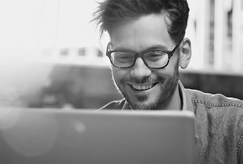 guy computer reading smiling